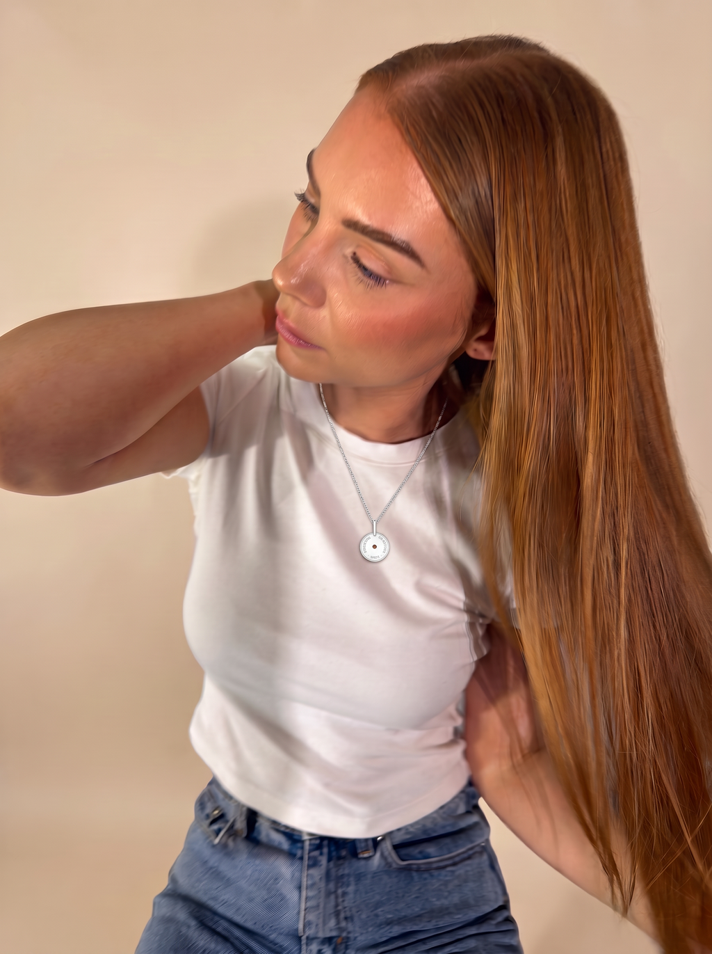 Model in a white tee wearing the Love · Gratitude · Strength Meaning Pendant