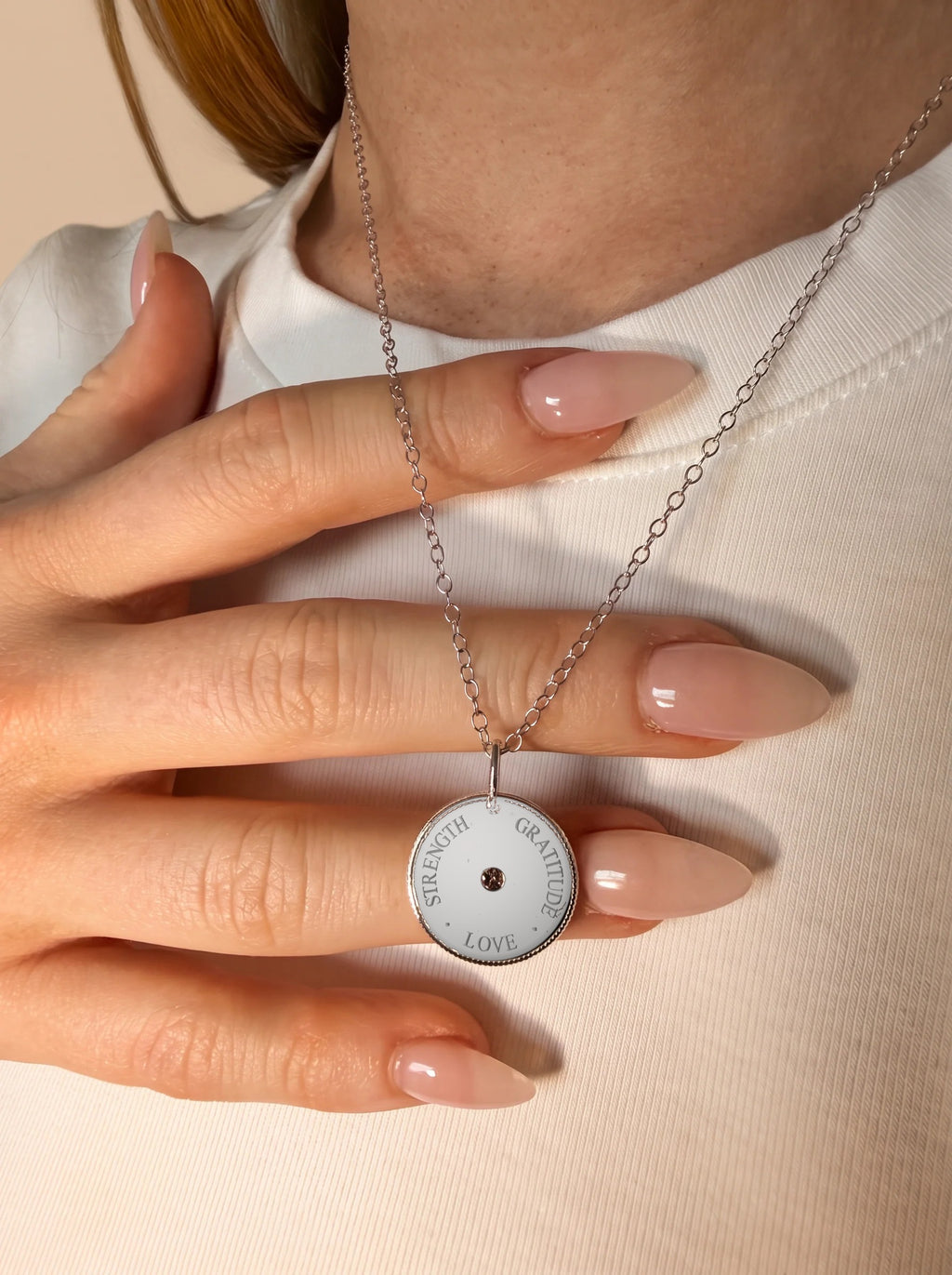 Love Gratitude Strength Meaning Pendant in silver, worn close-up
